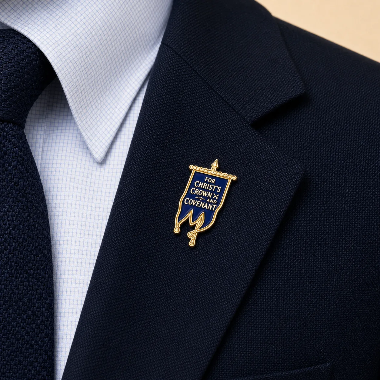 Covenanter Blue Banner lapel pin worn on the navy blazer