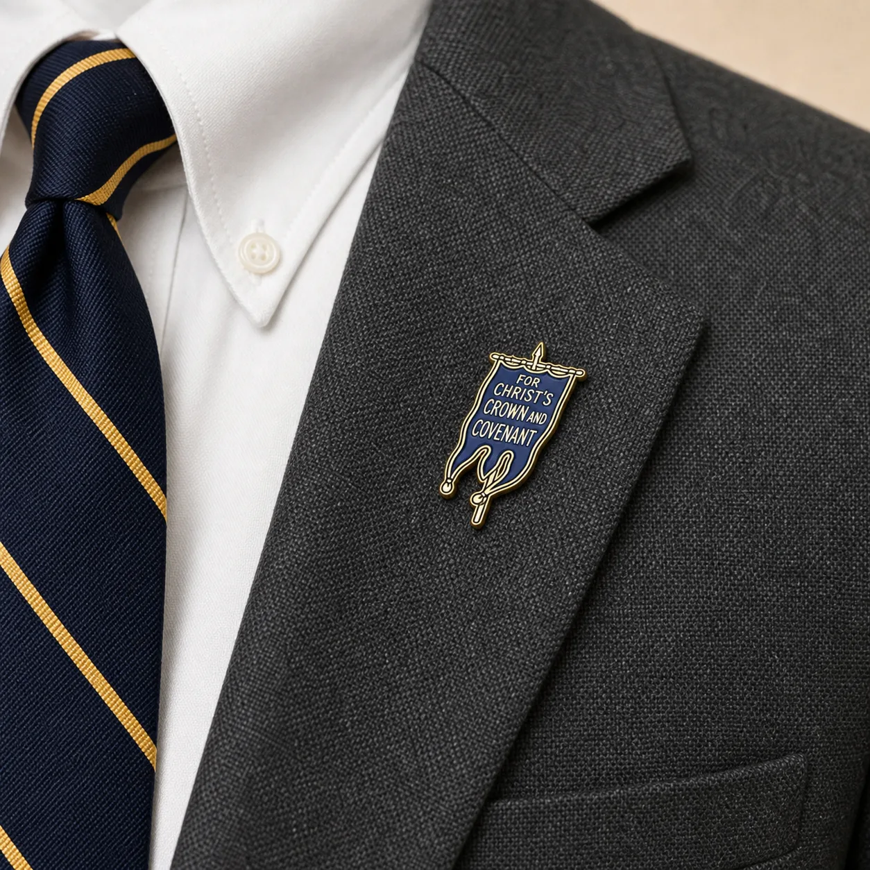 Covenanter Blue Banner lapel pin worn on the gray blazer