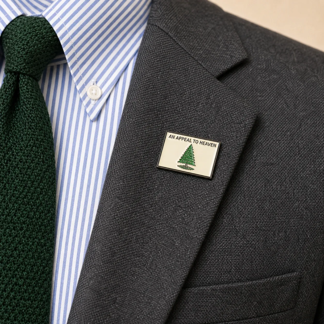 An Appeal to Heaven 2.0 lapel pin worn on the gray blazer