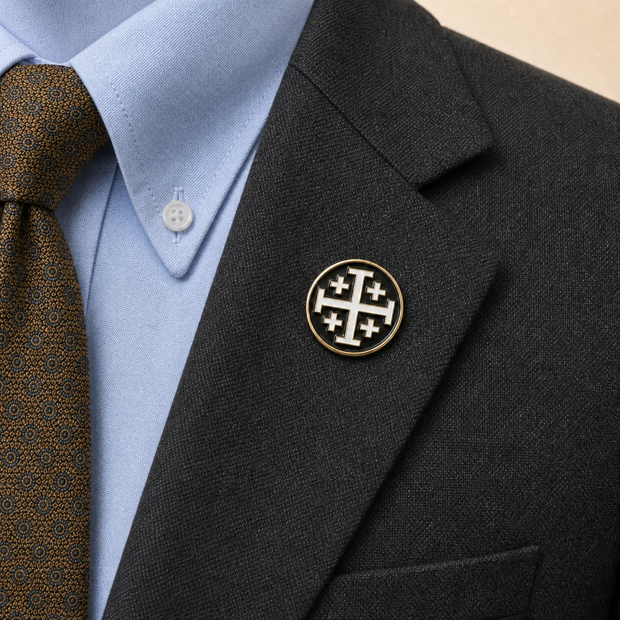 Jerusalem Cross, Black/White lapel pin worn on the gray blazer