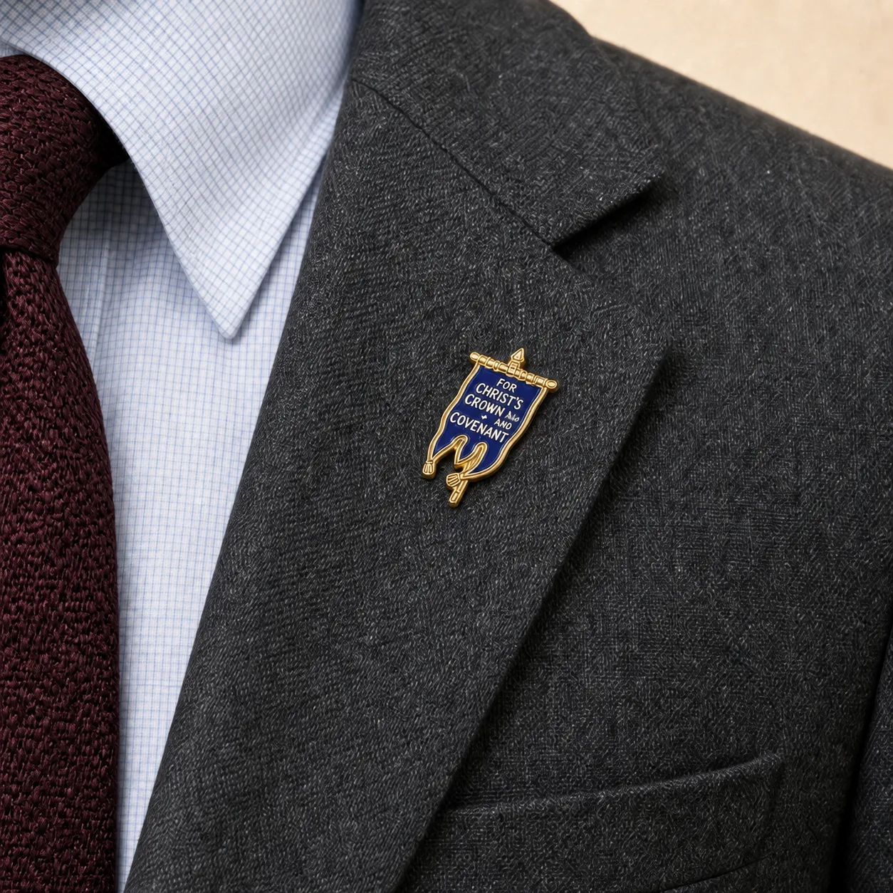 Covenanter Blue Banner lapel pin worn on the gray blazer
